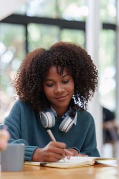 Young black African woman university student learning online using laptop computer. Smiling girl watch webinar or virtual education.