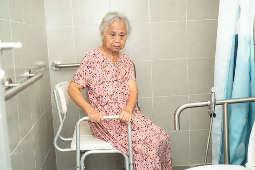 Asian senior or elderly old lady woman patient use toilet bathroom handle security in nursing hospital, healthy strong medical concept.
