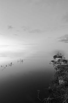 Mystical landscape of lagoon with infinite background.Black and white, water, land, lights and clouds