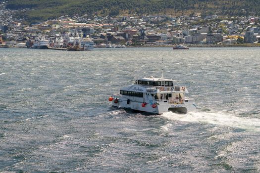 Ushuaia, Argentina - 28 January 2023: Elisabetta catamaran in rough seas returning to port