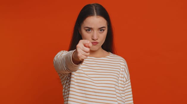 Angry aggressive pretty woman showing fig negative gesture, you dont get it anyway. Rapacious, avaricious, acquisitive. Body language. Refusal fig sign. Greedy avaricious girl on red background