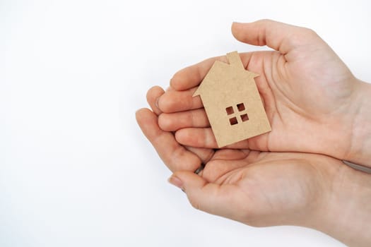 hands holding paper house, family home, homeless housing, mortgage crisis and home protecting insurance concept, foster home care, family day care, social distancing