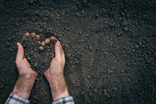 Agriculture symbol heart earth day. Handful of dirt hands heart shape. Male hands full of soil earth save environment day. Farmer hands soil ground earth dirt garden soil farm ground. Fertile ground