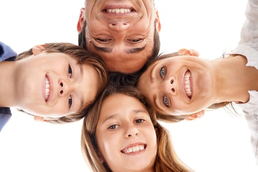 Family huddle. Low-angle shot of a happy family of four standing in a huddle