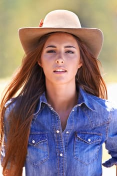 Learning how to rough it. Closeup of a young cowgirl enjoying the outdoors