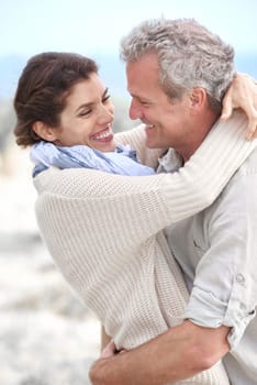 Blissful. A loving couple hugging each other affectionately outdoors