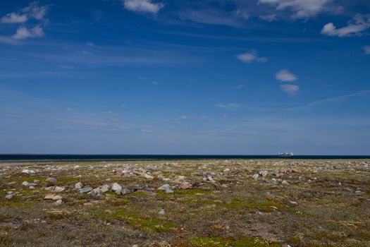 Fuel barge or tanker ship off the coast of Hudson Bay waiting to provide fuel for an arctic community, Nunavut, Canada