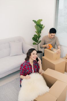 Young loving couple moving to a new house. Home and family concept.