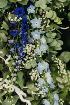 Wedding ceremony on the street on the green lawn.Decor with fresh flowers arches for the ceremony.