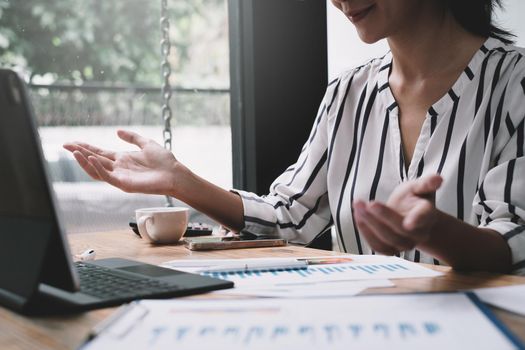 During a video conversation with her business team, a businesswoman discusses the stock market and the concept of working from home