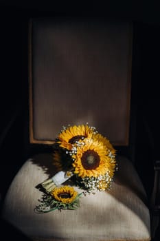 a wedding bouquet of sunflowers lies on an antique chair.Wedding Decor.