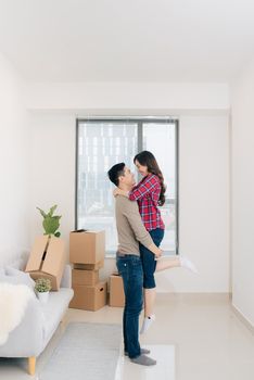 Couple moving new home. Happy married people buy new apartment