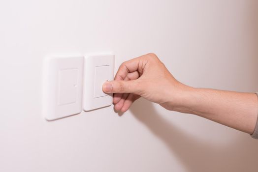 people pressing button for light on wall 