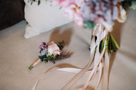 wedding bouquet with roses and boutonniere.The decor at the wedding.