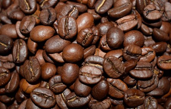 Roasted coffee beans, coffee, aromatic food and drinks. Top view flat texture. Close Up Background. All space filled with coffee beans. Selective depth of field