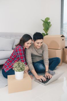 Young loving couple moving to a new house. Home and family concept.