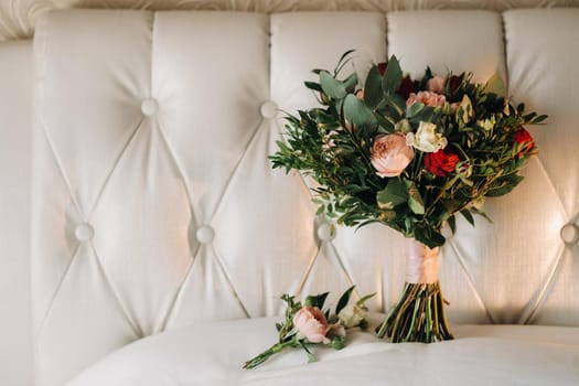 wedding bouquet with roses and boutonniere.The decor at the wedding.