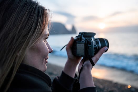 Woman travel sea. Happy tourist taking picture outdoors for memories. Woman traveler looks at the edge of the cliff on the sea bay of mountains, sharing travel adventure journey.