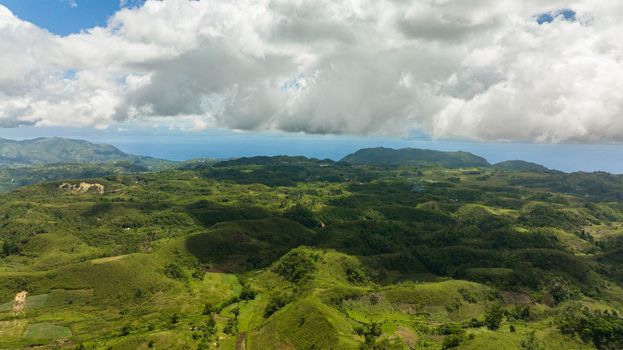 Aerial view of agricultural land among hills and mountains in a mountainous province. Libo hills. Cebu island, Philippines.