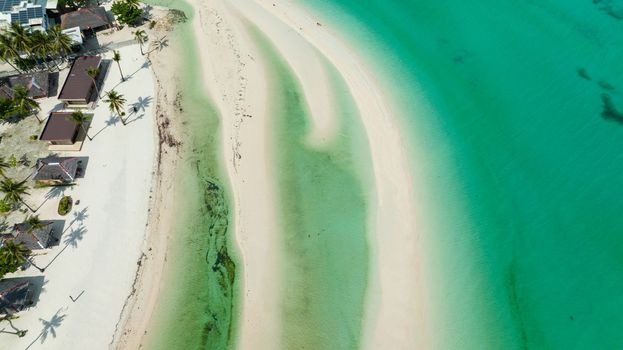 Sandy beach and blue sea in a tropical resort view from above. Bantayan island, Philippines.