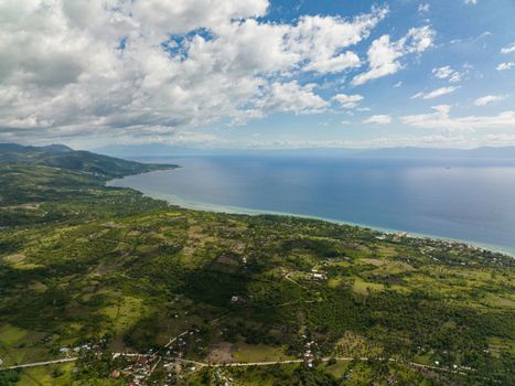 Aerial drone of coastline of the island of Cebu against the backdrop of the blue sea and the island of Negros. Philippines.