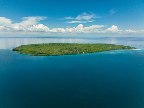 Tropical island against the blue sky and the ocean. Hilantagaan Island, Philippines.