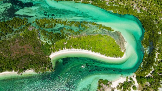 Aerial drone of blue lagoon with islands in turquoise water. Tropical landscape. Balidbid Lagoon, Bantayan island, Philippines.