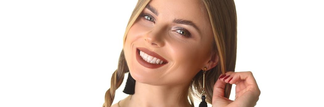 Happy woman with long pigtail and beautiful makeup. Evening stylish makeup concept