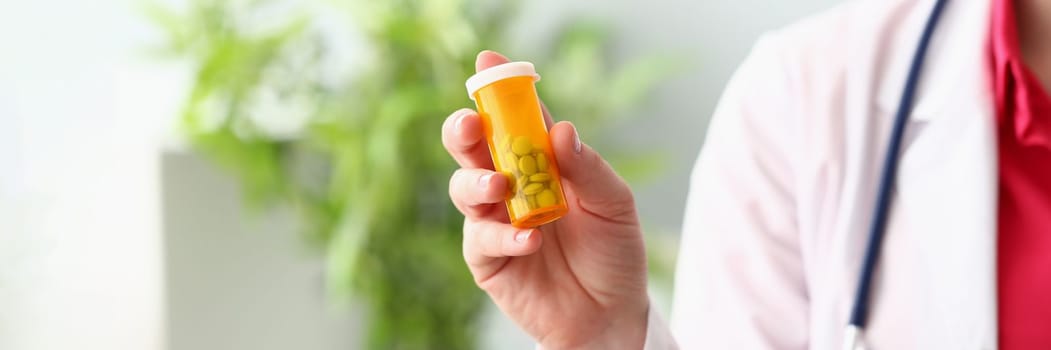 Female doctor hand holding medical pills or pill jar mockup. Medicine pharmacy prescription drugs or vitamins concept