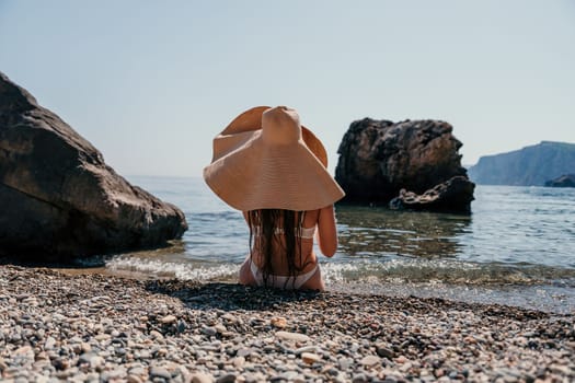 Woman travel sea. Happy tourist taking picture outdoors for memories. Woman traveler looks at the edge of the cliff on the sea bay of mountains, sharing travel adventure journey.