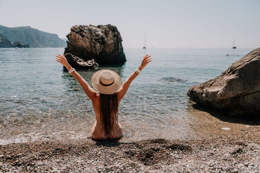 Woman travel sea. Happy tourist taking picture outdoors for memories. Woman traveler looks at the edge of the cliff on the sea bay of mountains, sharing travel adventure journey.