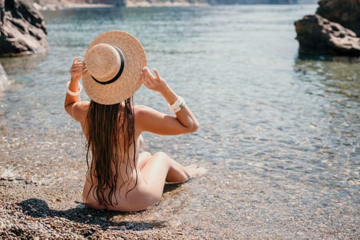 Woman travel sea. Happy tourist taking picture outdoors for memories. Woman traveler looks at the edge of the cliff on the sea bay of mountains, sharing travel adventure journey.