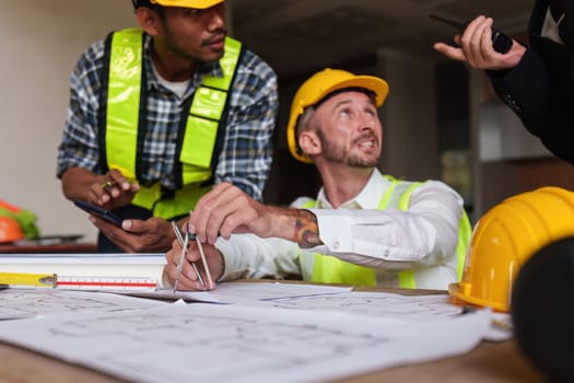 Civil Construction team working at renovate construction site. architectural plan, engineer sketching a construction project, green energy concept