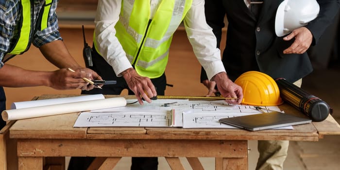 Civil Construction team working at renovate construction site. architectural plan, engineer sketching a construction project, green energy concept