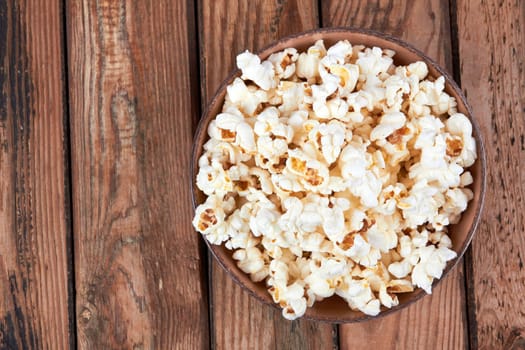 Popcorn in bowl food on wooden background
