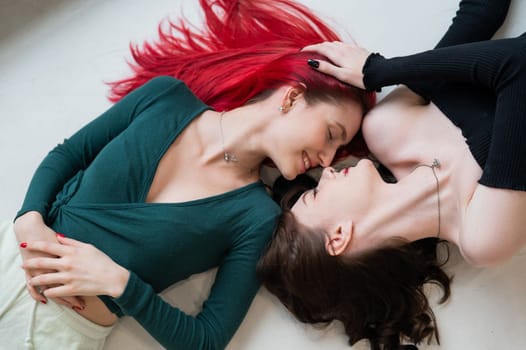 Top view of caucasian women lying and kissing
