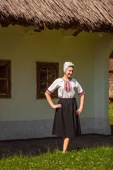 young woman in ukrainian national costume outdoors