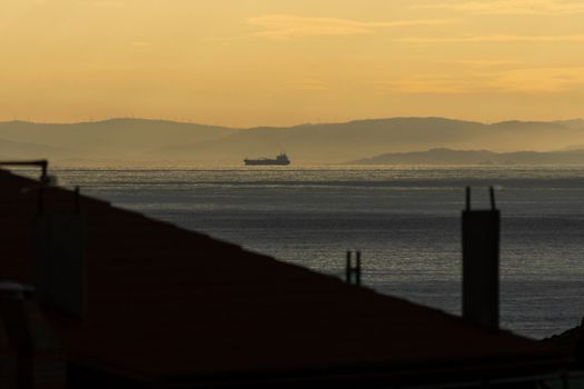 Cargo ship at sunset in the sea. High quality photo