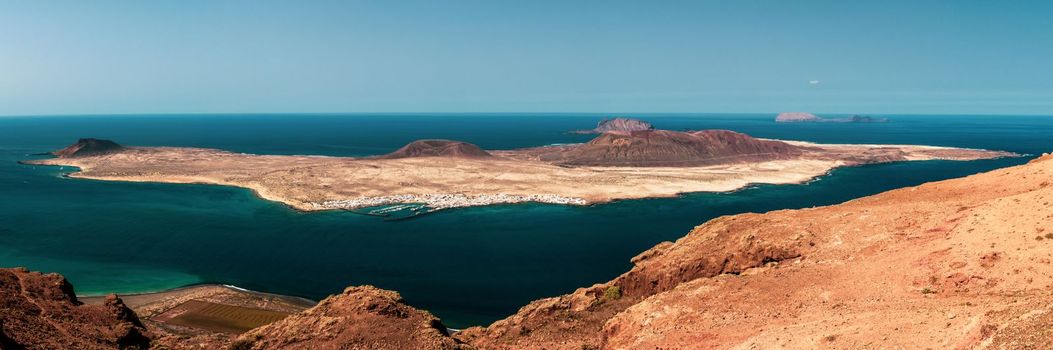Unique nature and beautiful colorful beaches of volcanic Lanzarote. View to the La Graciosa island. Canary islands. High quality photo