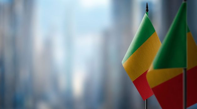 Small flags of the Mali on an abstract blurry background.
