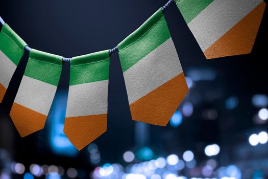 A garland of Ireland national flags on an abstract blurred background.