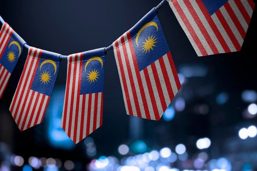 A garland of Malaysia national flags on an abstract blurred background.