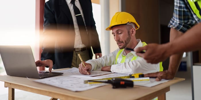 Civil Construction team working at renovate construction site. architectural plan, engineer sketching a construction project, green energy concept