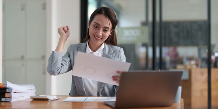 Young happy woman using laptop and celebrating victory and success, have good news, job celebrating achievement