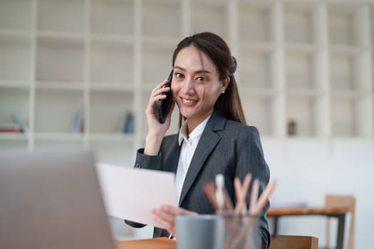 Beautiful business woman talking on the mobile phone. Management, planning and networking phone call concept