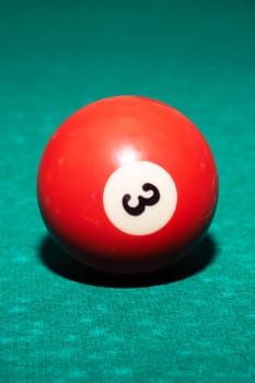 Billiard ball on a green table close up