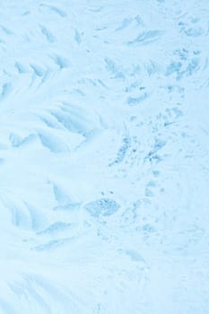 Blue frost pattern on glass closeup, background or texture