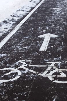 Symbol of a bike path on the sidewalk in the snow