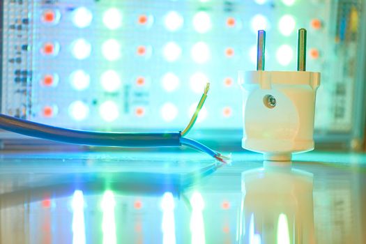 a semiconductor diode which glows when a voltage is appliedElectrical equipment for connection. Three core electric cable and lighting LED lamp.