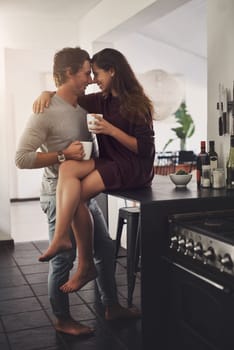 Romance starts the day off just right. an affectionate young couple having a coffee break at home
